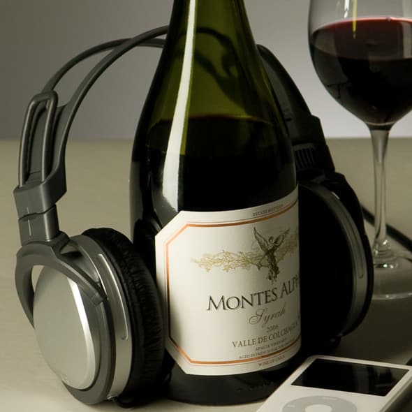 Wine bottle with headphones and glass