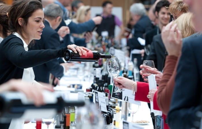 Wine tasting event with attendees mingling.