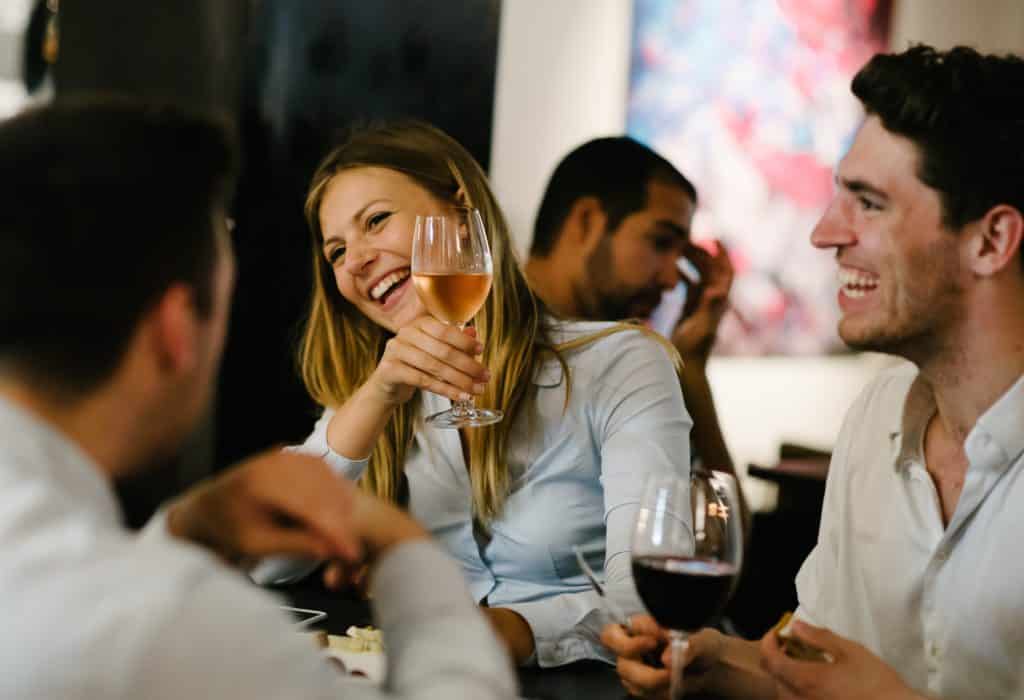 Friends enjoying wine and laughter.