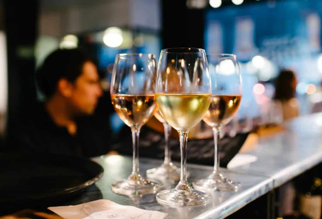 Glasses of white wine on bar